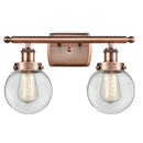 Beacon Bath Vanity Light shown in the Antique Copper finish with a Clear shade