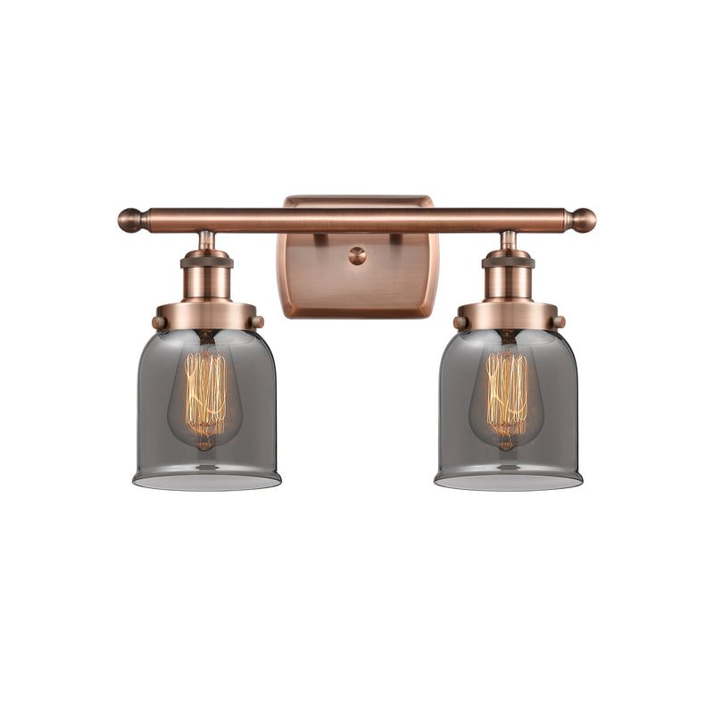 Bell Bath Vanity Light shown in the Antique Copper finish with a Plated Smoke shade