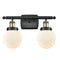 Beacon Bath Vanity Light shown in the Black Antique Brass finish with a Matte White shade