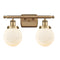 Beacon Bath Vanity Light shown in the Brushed Brass finish with a Matte White shade