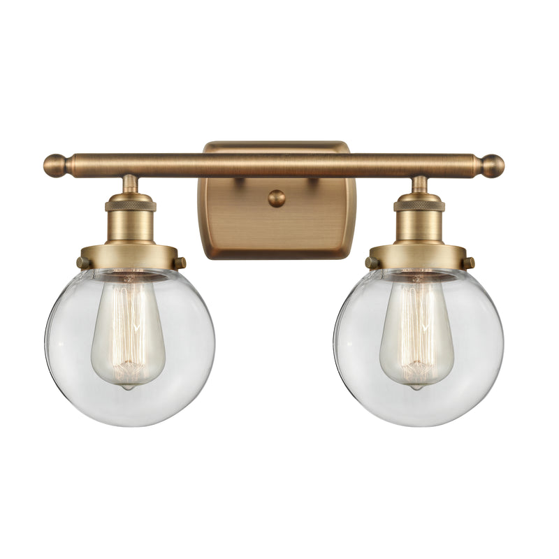 Beacon Bath Vanity Light shown in the Brushed Brass finish with a Clear shade