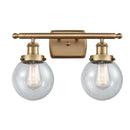 Beacon Bath Vanity Light shown in the Brushed Brass finish with a Seedy shade