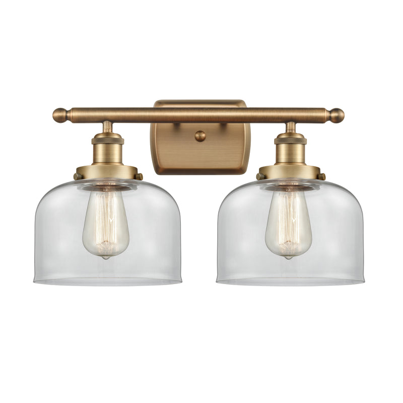 Bell Bath Vanity Light shown in the Brushed Brass finish with a Clear shade