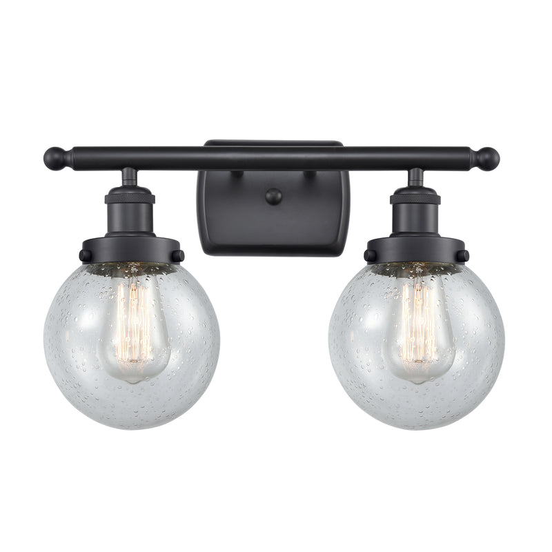 Beacon Bath Vanity Light shown in the Matte Black finish with a Seedy shade