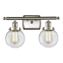 Beacon Bath Vanity Light shown in the Brushed Satin Nickel finish with a Clear shade