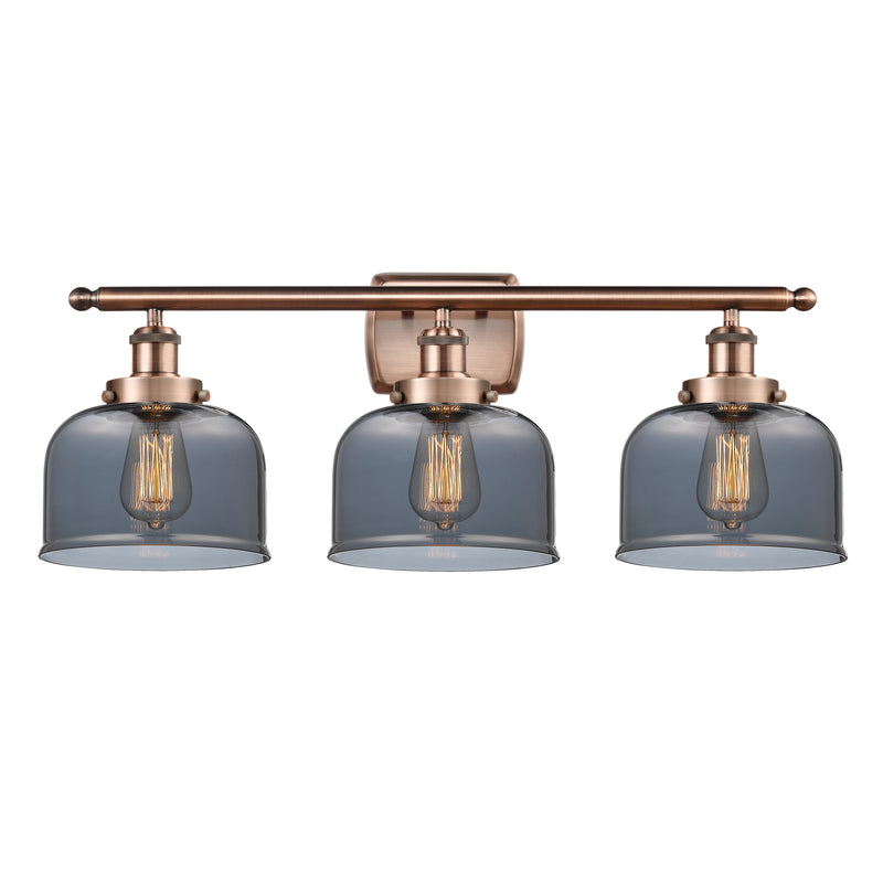 Bell Bath Vanity Light shown in the Antique Copper finish with a Plated Smoke shade