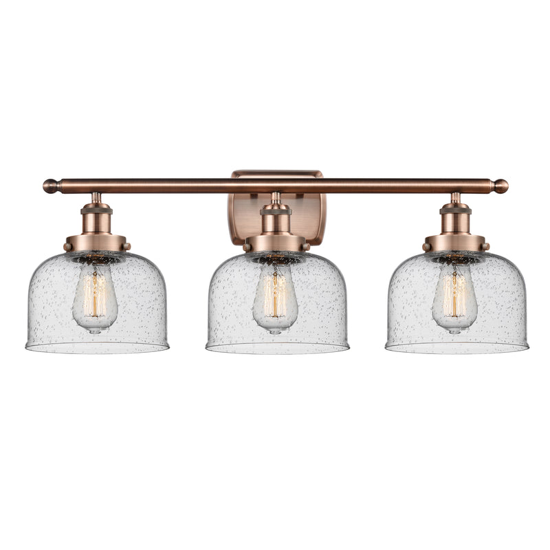 Bell Bath Vanity Light shown in the Antique Copper finish with a Seedy shade