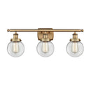 Beacon Bath Vanity Light shown in the Brushed Brass finish with a Clear shade