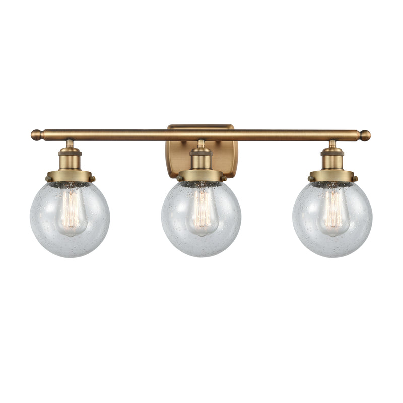 Beacon Bath Vanity Light shown in the Brushed Brass finish with a Seedy shade