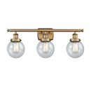 Beacon Bath Vanity Light shown in the Brushed Brass finish with a Seedy shade