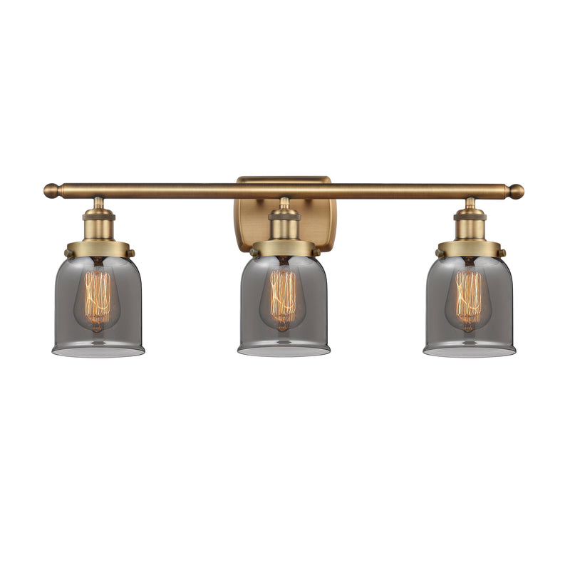 Bell Bath Vanity Light shown in the Brushed Brass finish with a Plated Smoke shade