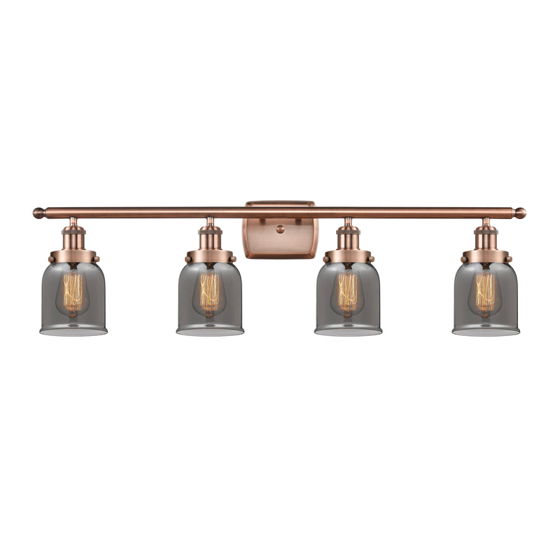 Bell Bath Vanity Light shown in the Antique Copper finish with a Plated Smoke shade