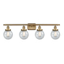 Beacon Bath Vanity Light shown in the Brushed Brass finish with a Seedy shade